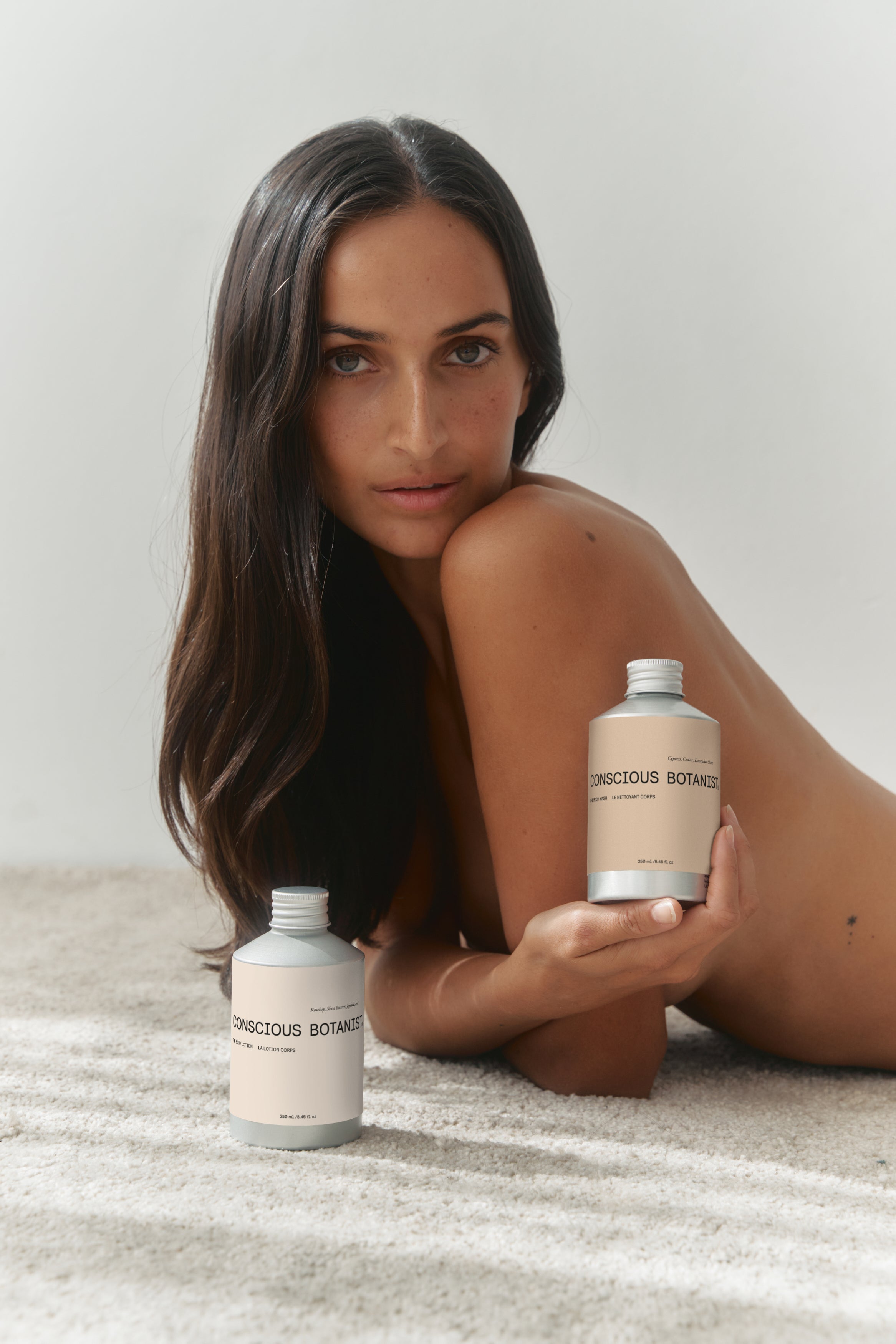 Hyaluronic acid body lotion bottle, showing product packaging and woman. Natural hydrating lotion with rosehip oil and shea butter for radiant skin.